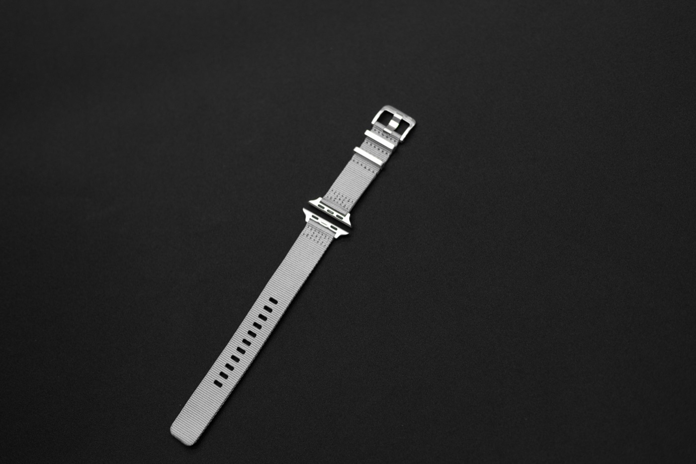 Lattice AW Buckle Titanium in Graphene Grey, with the Apple Watch connector and titanium pin buckle.